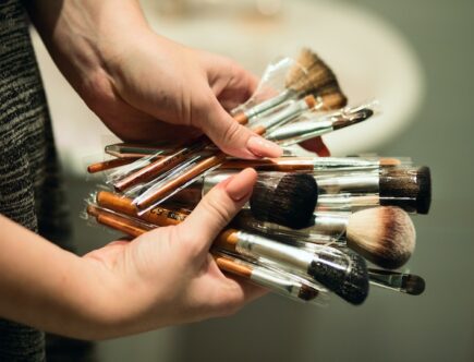 Person Holding Makeup Brushes