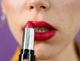 A Woman Applying Red Lipstick